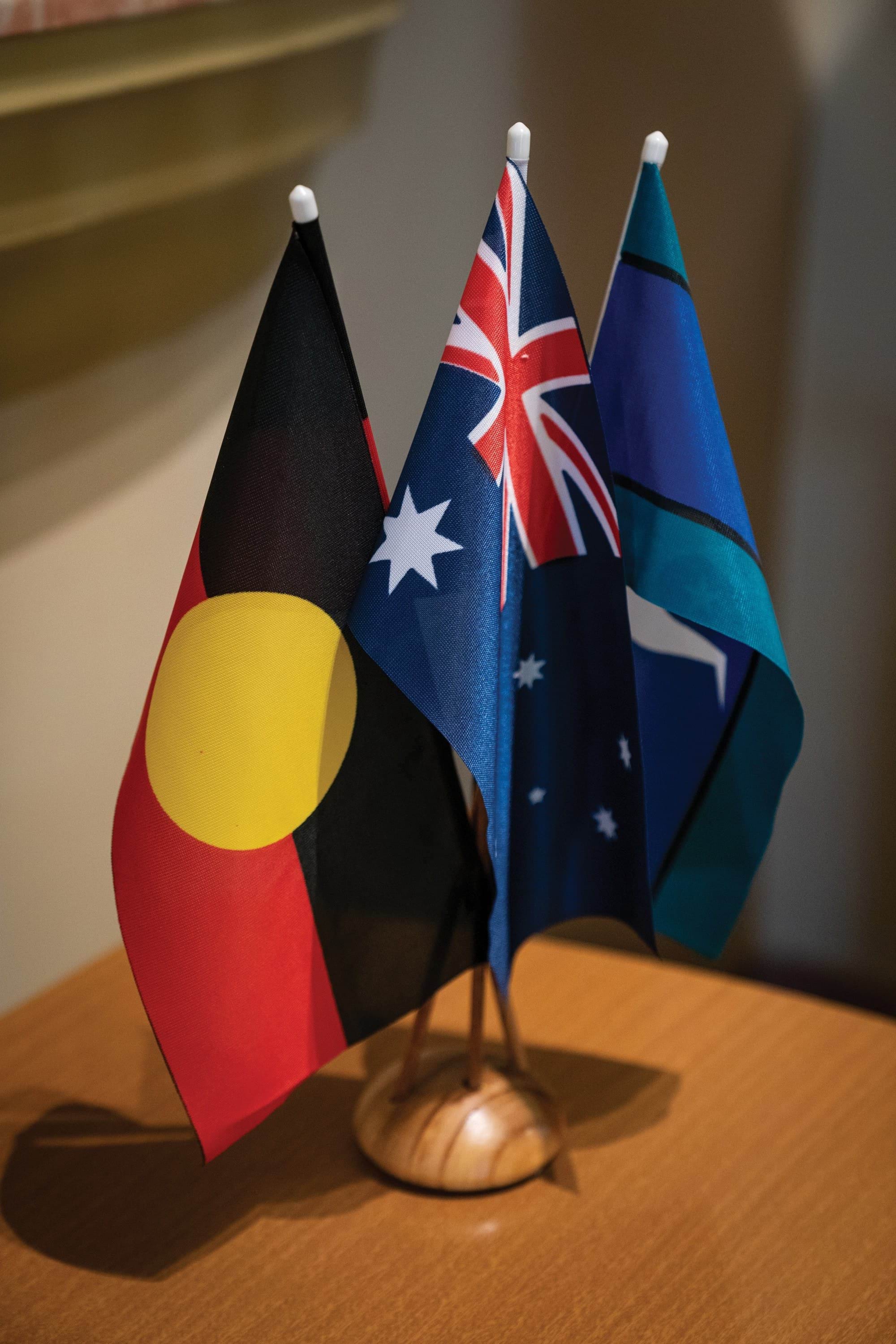 The Australian flag, the Aboriginal flag, and the Torres Strait Islander flag. 